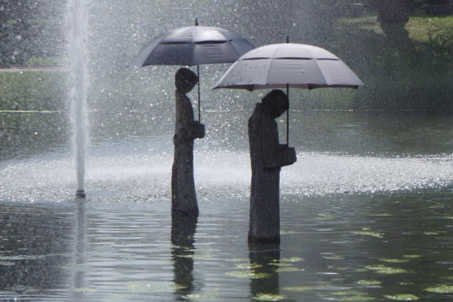 Two statues standing in the rain